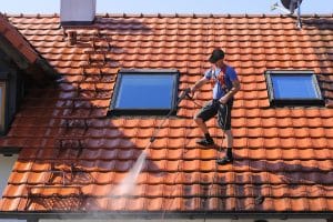 Worker is cleaning the roof
